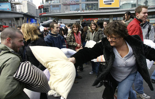 Adults having fun at the pillow fight at Yonge-Dundas Square in Toronto 2009